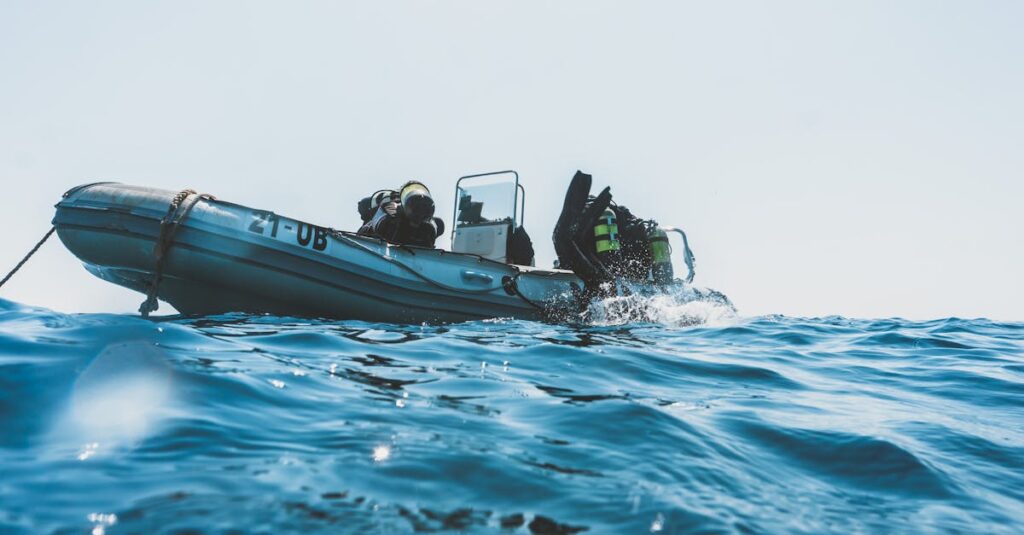 pexels-photo-3113238-3113238 Scuba divers equipped for an ocean dive prepare from an inflatable boat on a sunny day.
