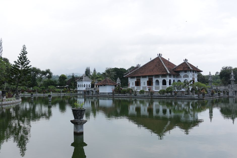 Beautiful view of Taman Ujung Water Palace in Karangasem, Bali, with reflections on the serene water.